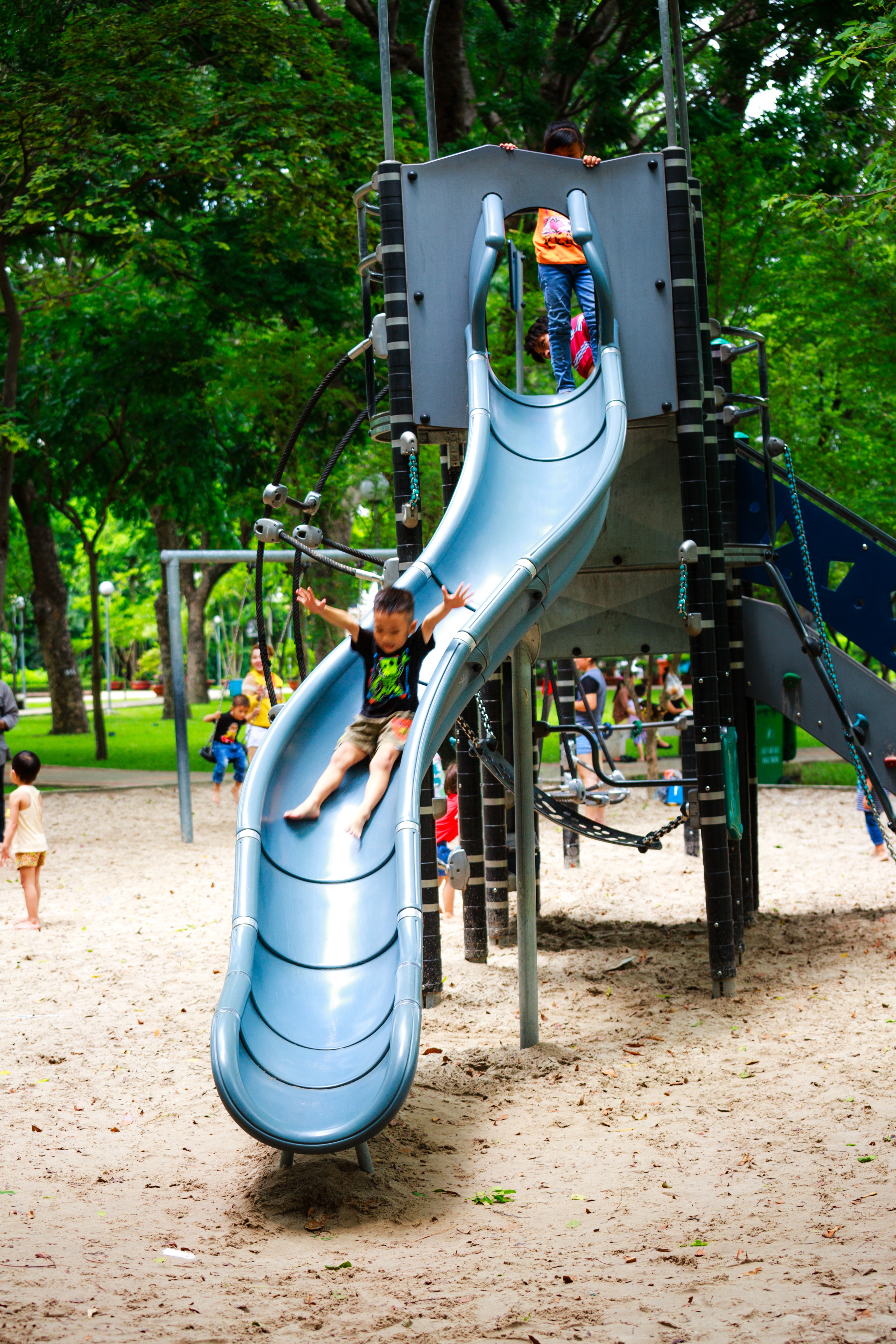 boy-playing-on-slide-in-playground-2143761